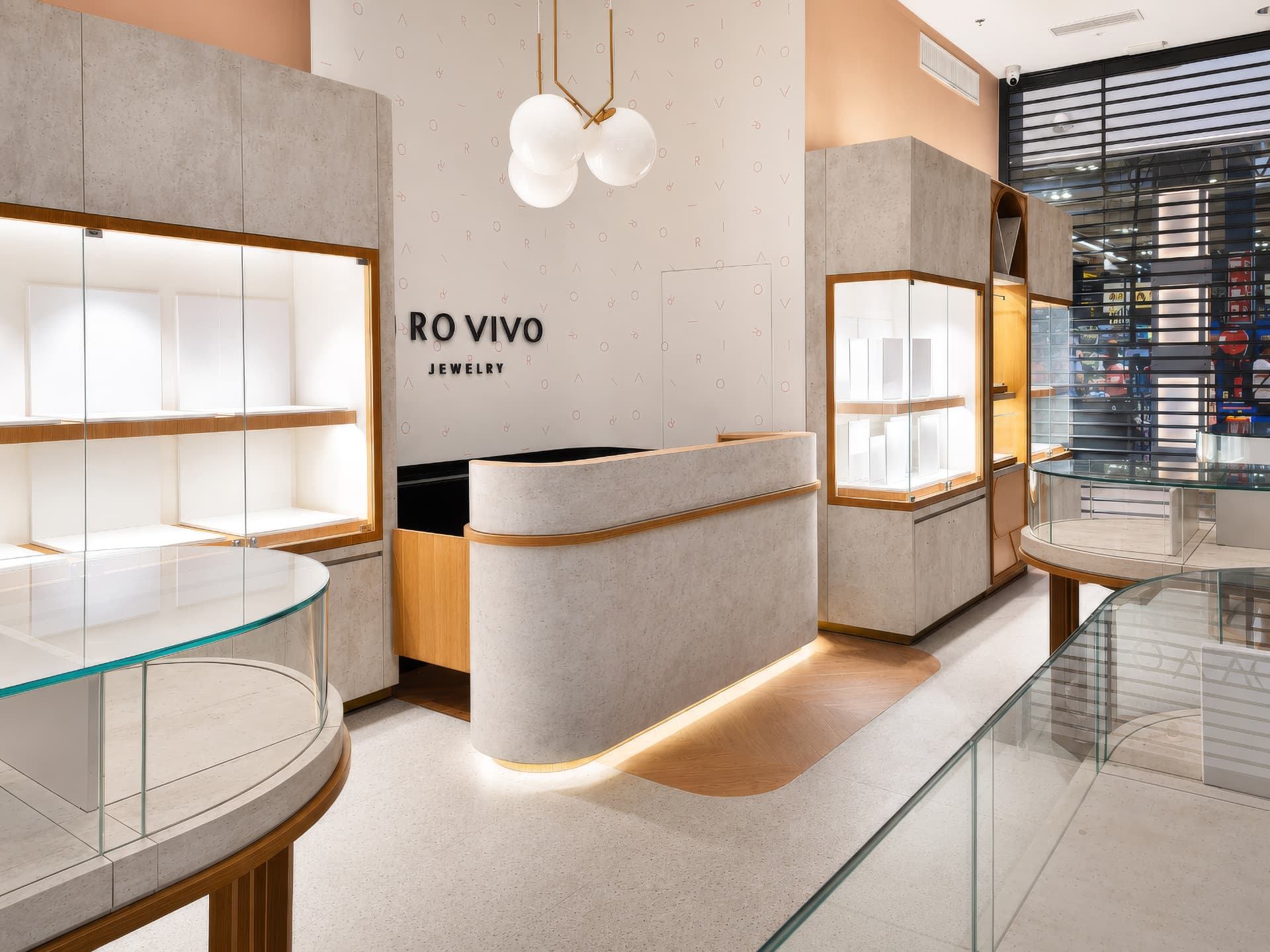 Curved stone-clad reception counter under brand signage