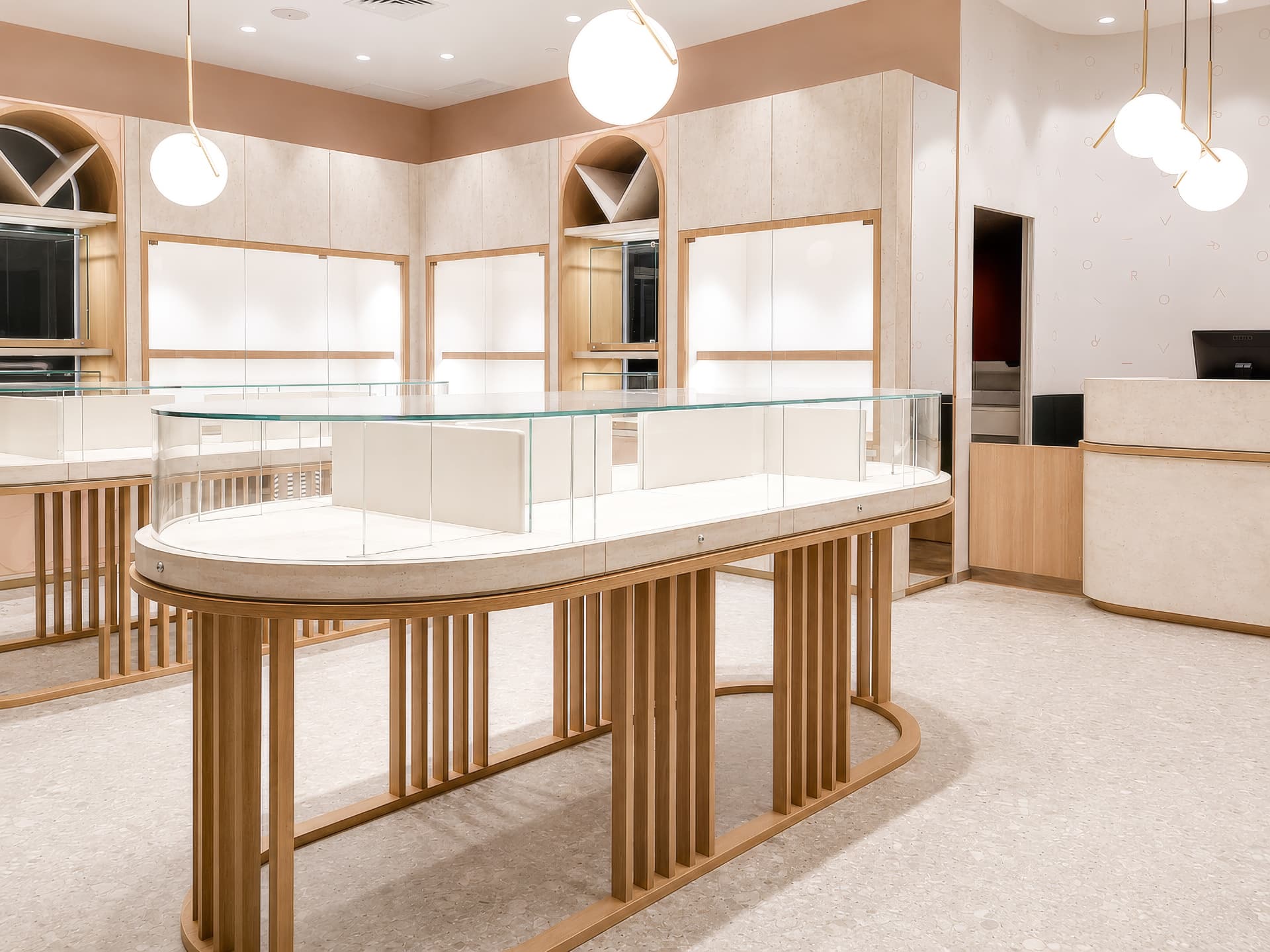 Central curved-glass showcase with illuminated wall vitrines
