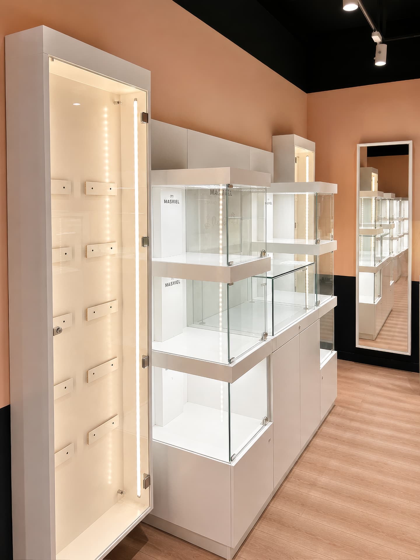 White wall unit with illuminated glass cubes and a lit vertical niche