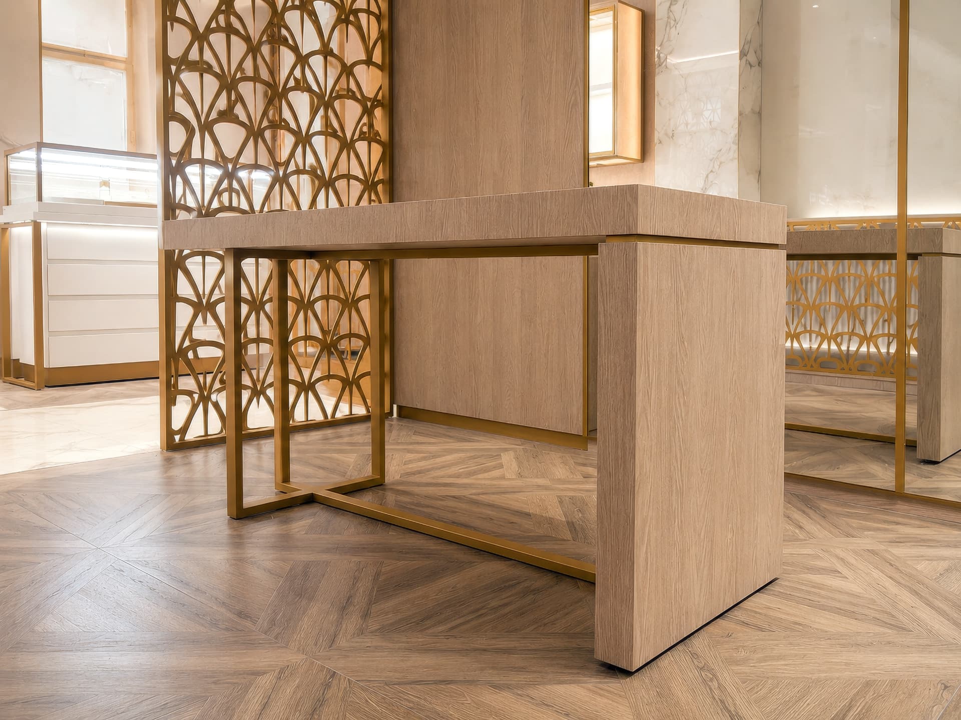 Detail of oak console with satin brass frame and Art Deco screen