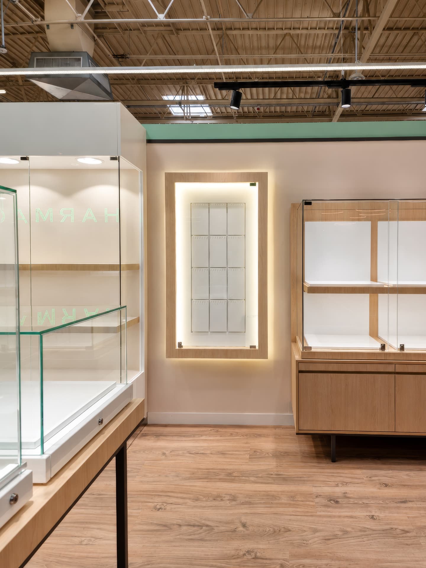 Illuminated wall niche between glass and oak display cabinets