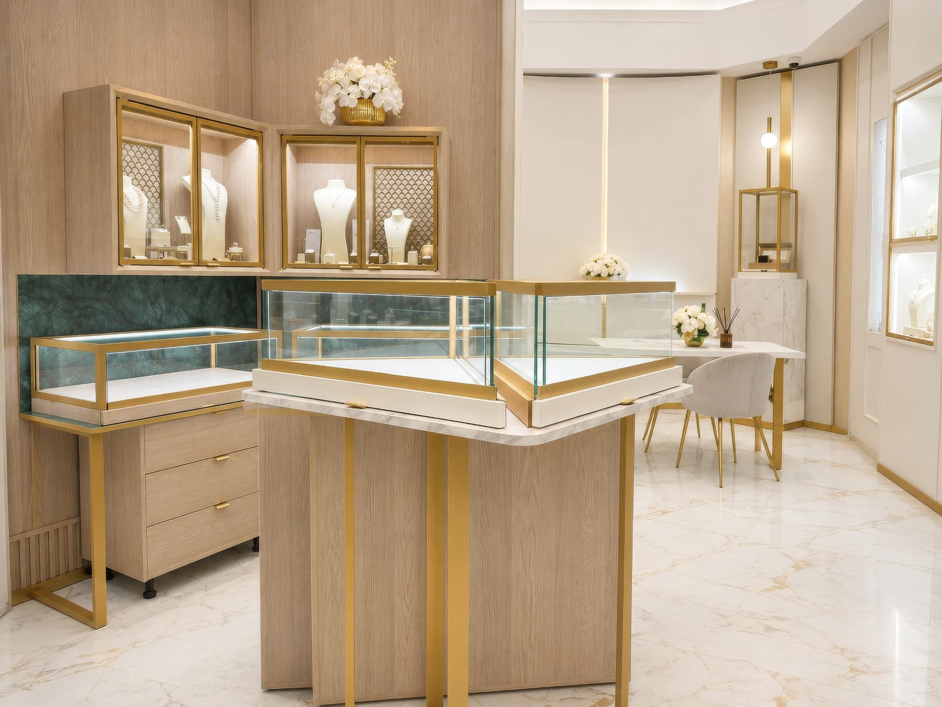 Corner showcase with green marble backdrop and brass-framed glass cases