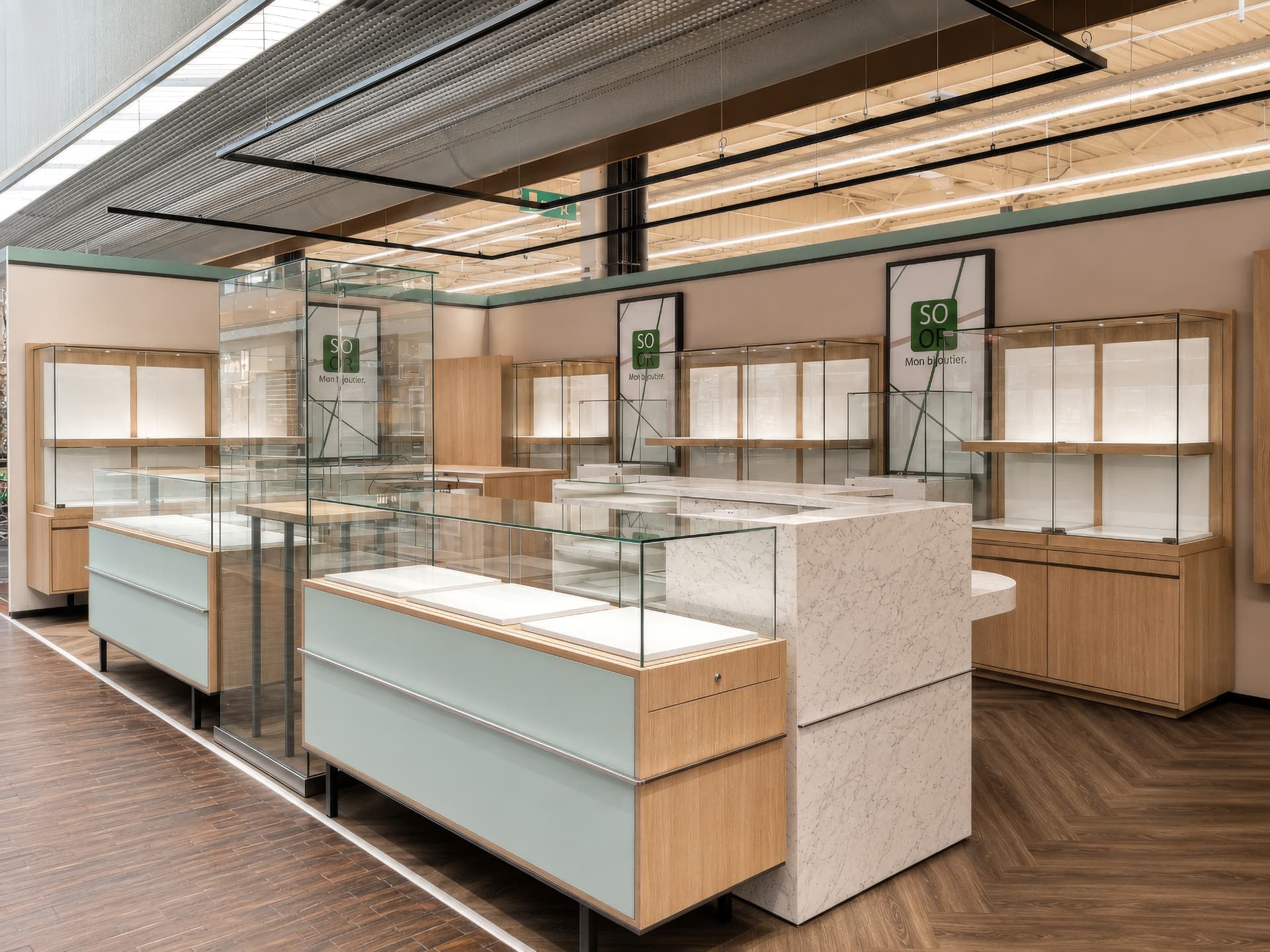 Counter islands with composite marble service desk and oak wall vitrines