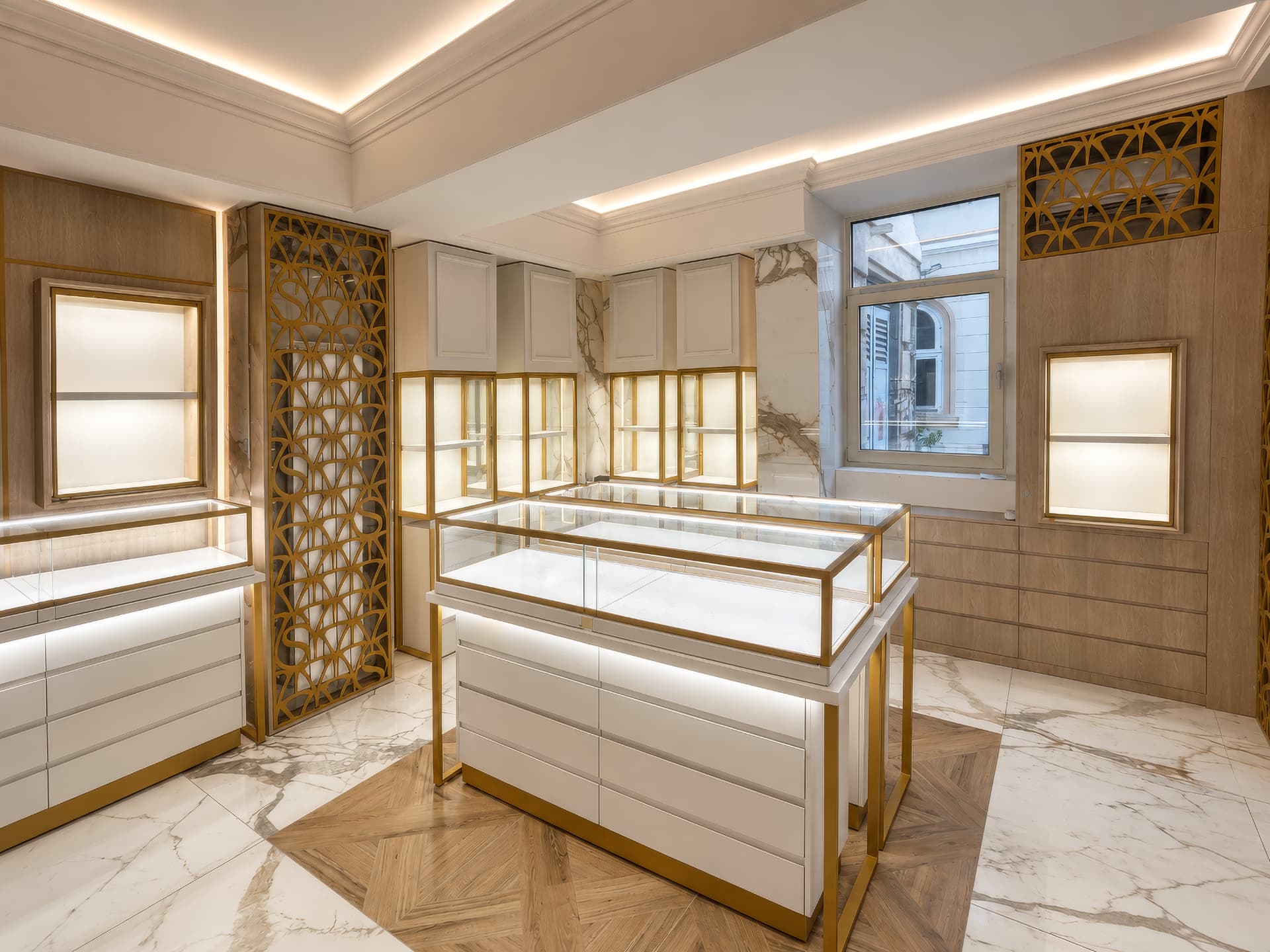 Display room with laser-cut brass screen and marble panels