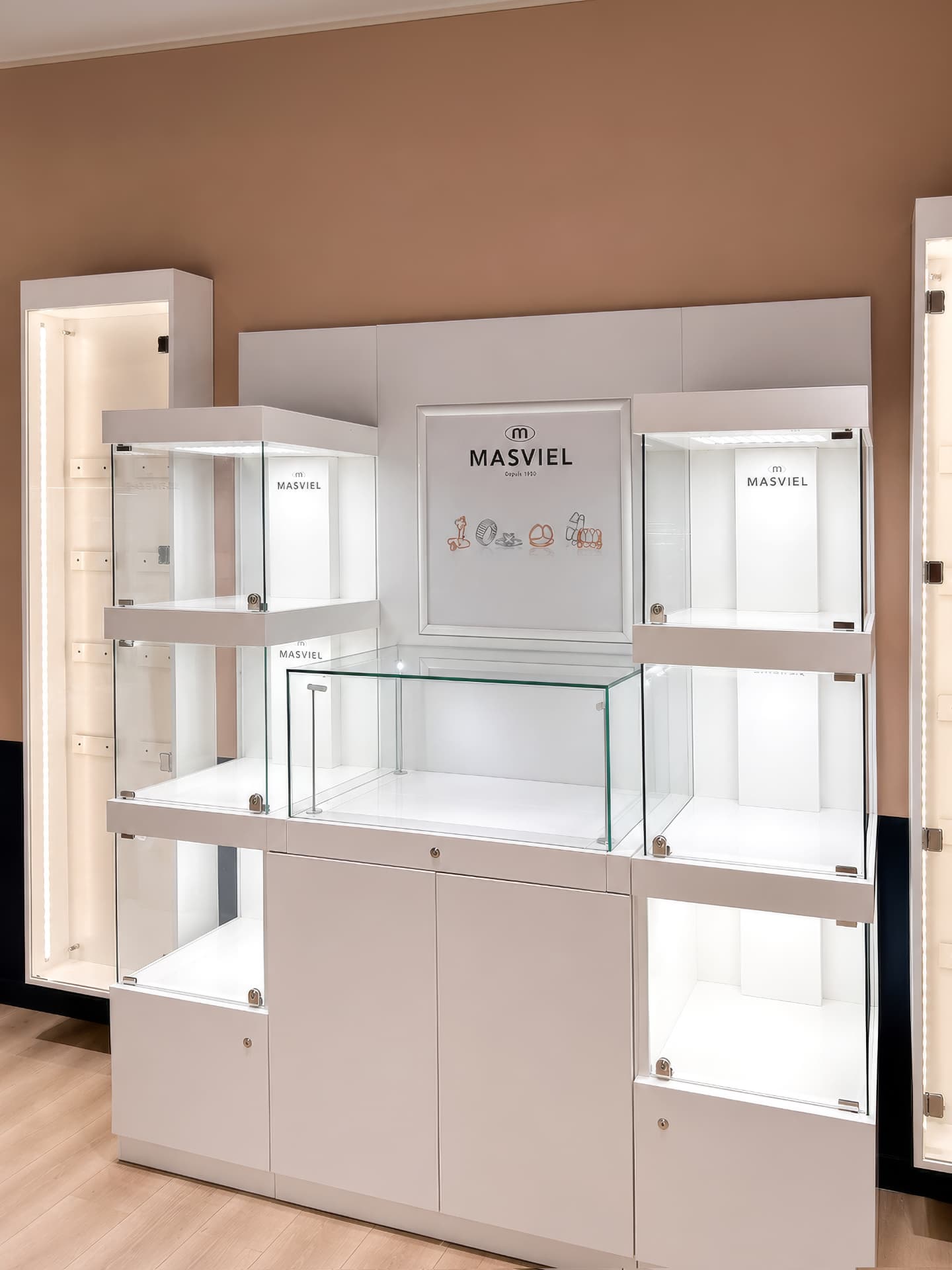 Wall display unit with lit glass cases and a branded panel