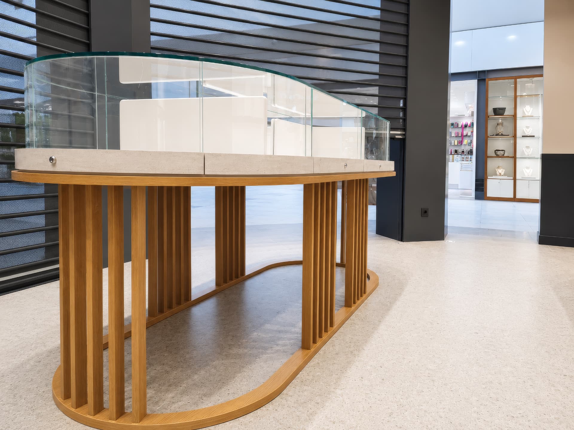 Island vitrine with curved glass seen from the mall gallery