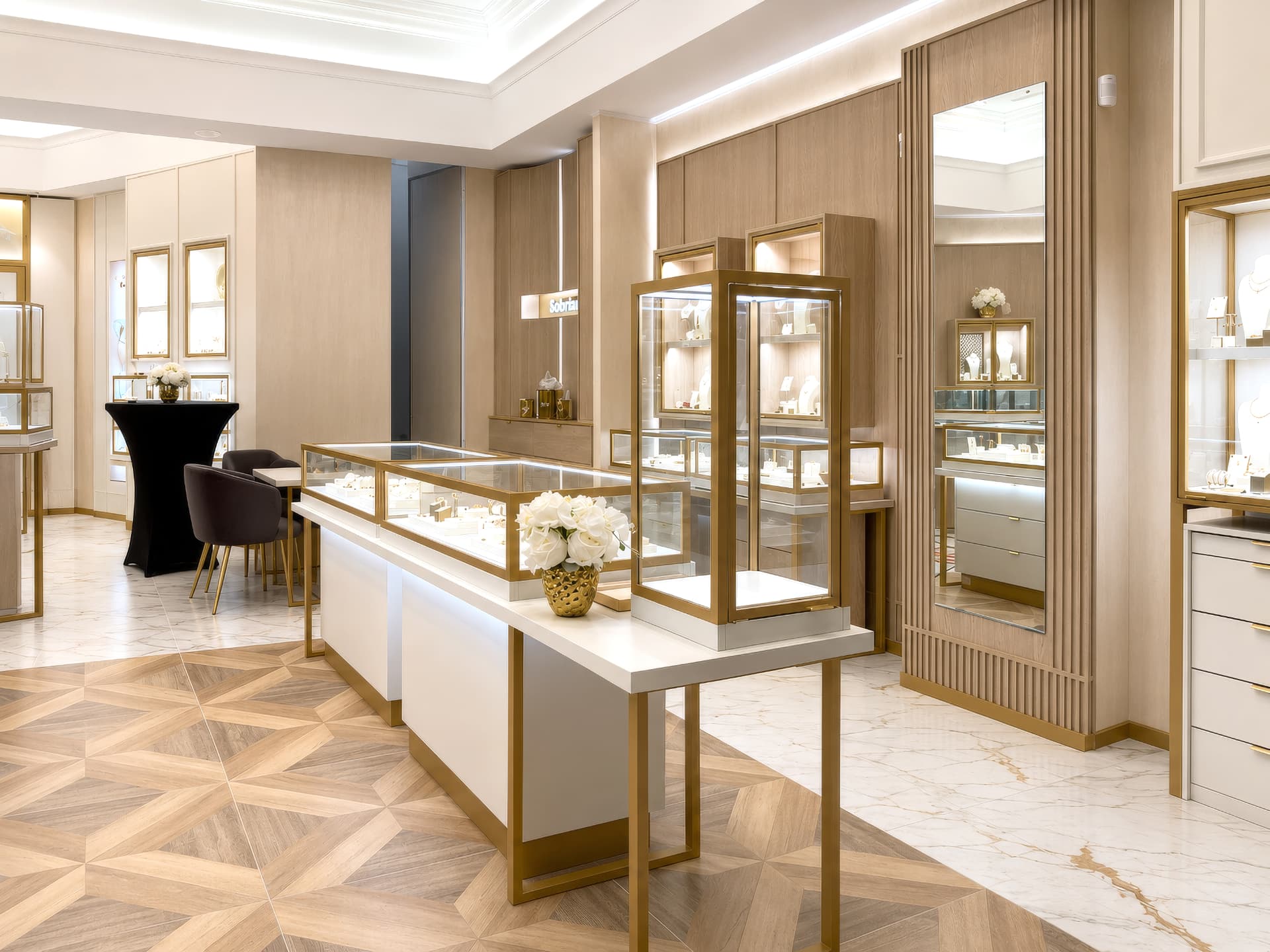 Island counters with tall brass and glass tower vitrine
